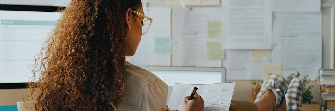 Girl with glasses writing