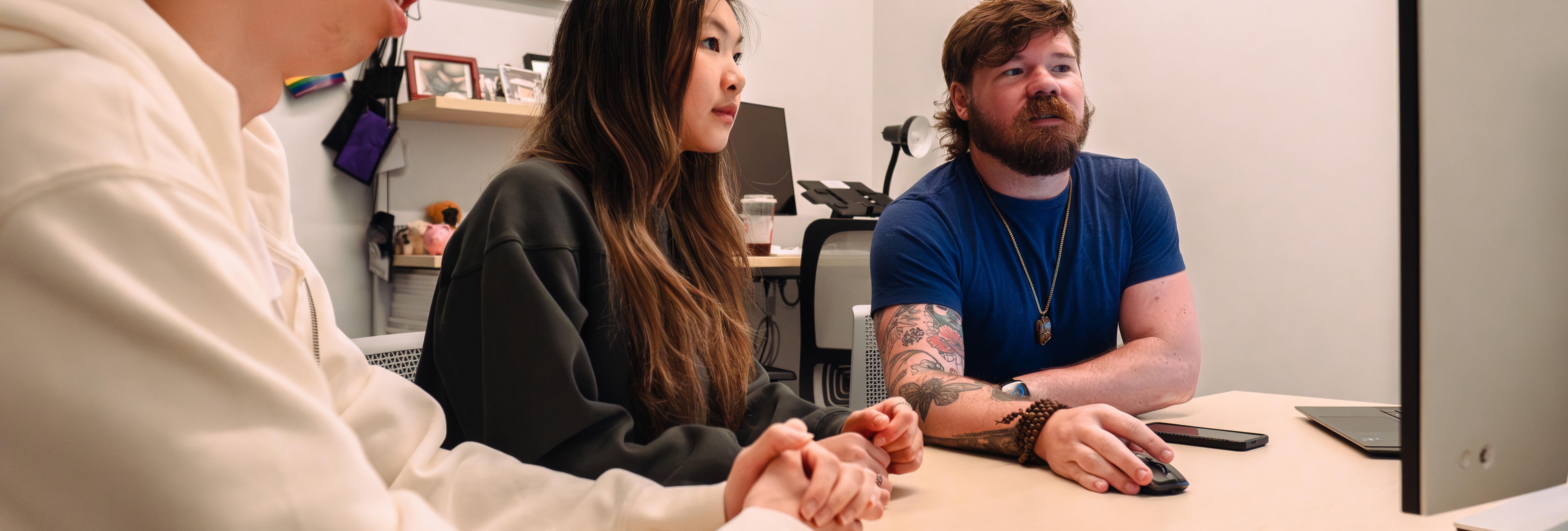 student and librarian looking at a monitor