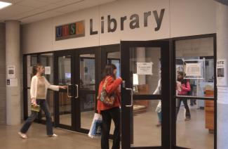 front doors of the library with people entering and exiting