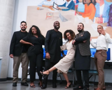 Excerpt of a larger group shot showing a group of people in front of the new mural